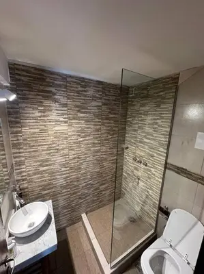 a bathroom with a shower and a toilet and a sink at Rondeau Suite in Cordoba