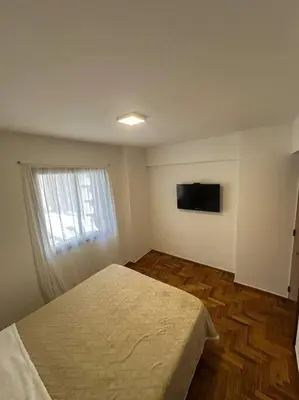a bedroom with a bed and a television on the wall at Rondeau Suite in Cordoba