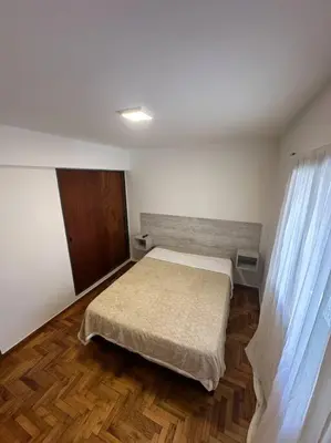 a bedroom with a bed and a wooden floor at Rondeau Suite in Cordoba