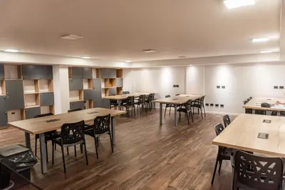 a large room with tables and chairs and wooden floors at Departamento 114 - Edificio VILAUT by INMOVE Temporarios in Cordoba