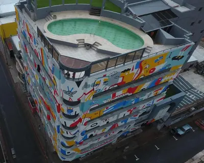 a building with a pool on the side of it at Departamento 114 - Edificio VILAUT by INMOVE Temporarios in Cordoba