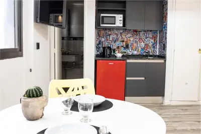 a kitchen with a white table and a red cabinet at Departamento 503 - Edificio VILAUT by INMOVE Temporarios in Cordoba