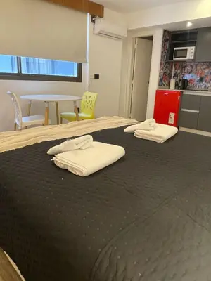 a large bed with two white towels on top of it at Departamento 503 - Edificio VILAUT by INMOVE Temporarios in Cordoba