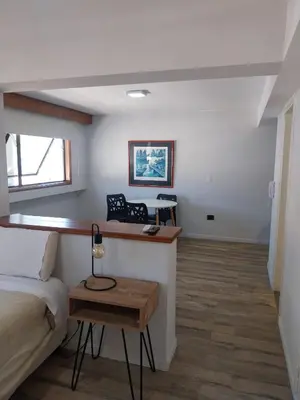 a bedroom with a bed and a desk in a room at Departamento 610 - Edificio VILAUT by INMOVE Temporarios in Cordoba