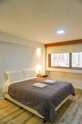 a bedroom with a bed with two towels on it at Departamento 611 - Edificio VILAUT by INMOVE Temporarios in Cordoba