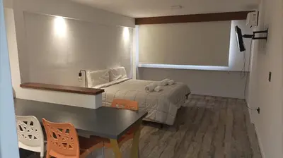 a small room with a bed and a table at Departamento 611 - Edificio VILAUT by INMOVE Temporarios in Cordoba