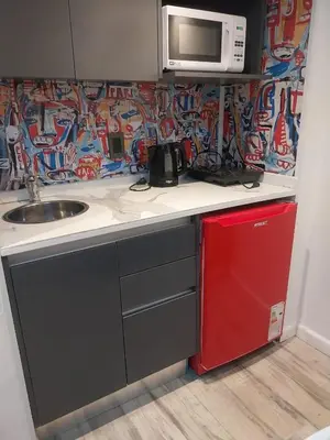 a small kitchen with a sink and a microwave at Departamento 611 - Edificio VILAUT by INMOVE Temporarios in Cordoba