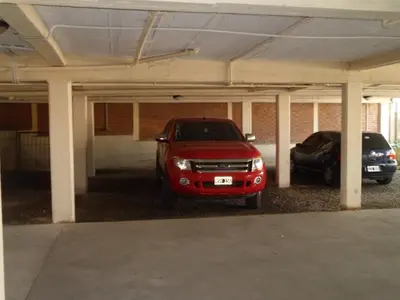 two cars are parked in a parking garage at Altos del Plata in Villa Carlos Paz