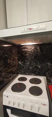 a white stove top oven in a kitchen at Departamento céntrico de 2 habitaciones y Pileta Edificio Sommet in Villa Carlos Paz