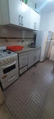a kitchen with a stove and a sink at Depto Morandini in Villa Carlos Paz