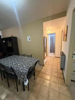 a dining room with a table and a television at Depto Morandini in Villa Carlos Paz