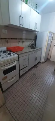 a kitchen with a stove and a sink at Depto Morandini in Villa Carlos Paz