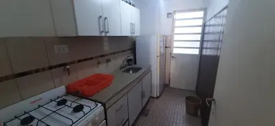 a small kitchen with a stove and a sink at Depto Morandini in Villa Carlos Paz