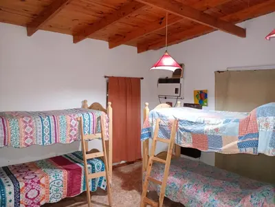 a room with two bunk beds and two chairs at El Dpto de Gabicito III in Cordoba
