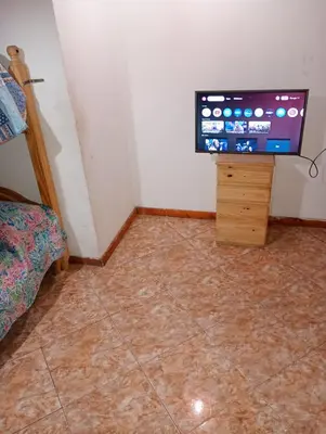a room with a tiled floor with a flat screen tv at El Dpto de Gabicito III in Cordoba