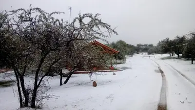 a snow covered road with a house on it at Corazon de Montaña in Merlo