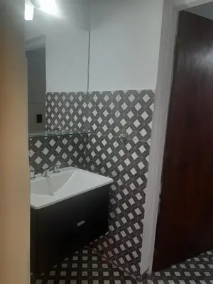 a bathroom with a sink and a mirror at Cabañas R&E in Mina Clavero