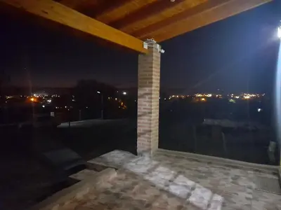 a room with a view of the city at night at Cabañas R&E in Mina Clavero