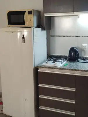 a kitchen with a stove and a refrigerator at Temporario Alberdi in Cordoba