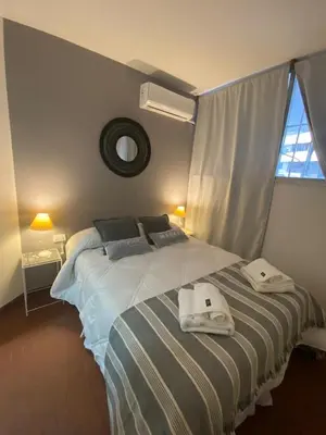 a bedroom with a bed with towels on it at Dpto confortable, super equipado para 4 huéspedes y cerca de todo! in Cordoba