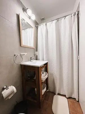 a bathroom with a white shower curtain and a sink at Dpto confortable, super equipado para 4 huéspedes y cerca de todo! in Cordoba
