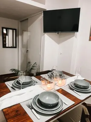 a dining room table with plates and wine glasses at Dpto confortable, super equipado para 4 huéspedes y cerca de todo! in Cordoba