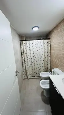 a small bathroom with a toilet and a shower at Apto amoblado temporario in Cordoba