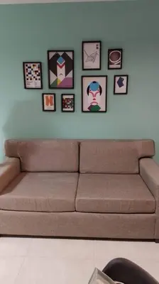 a couch in a living room with pictures on the wall at Apto amoblado temporario in Cordoba