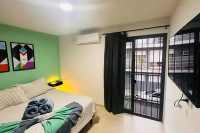a bedroom with a bed and a large window at Apto amoblado temporario in Cordoba