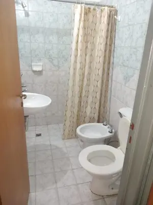 a bathroom with a toilet and a sink at Departamento en la cañada in Cordoba