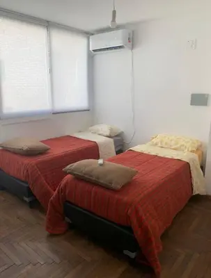 a room with two beds in a room at Departamento en la cañada in Cordoba