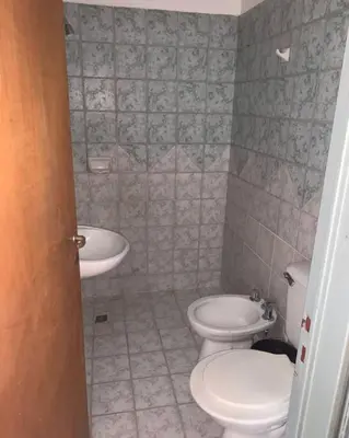 a bathroom with a toilet and a sink at Departamento en la cañada in Cordoba