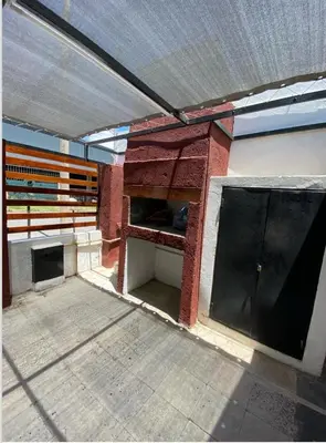 an empty room with a building with a pizza oven at La casita in Villa Carlos Paz