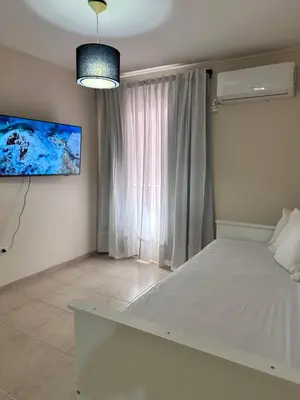 a bedroom with a white bed and a large window at Departamento Premium, Paseo Buen Pastor in Cordoba