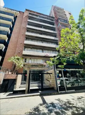 a tallartment building with a tree in front of it at Departamento Premium, Paseo Buen Pastor in Cordoba