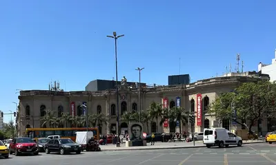 a large building with cars parked in front of it at Departamento Premium, Paseo Buen Pastor in Cordoba