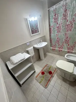 a bathroom with a white toilet and a sink at Departamento Premium, Paseo Buen Pastor in Cordoba