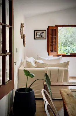 a room with two beds and a potted plant at Anastasia Rústica y acogedora in Cordoba