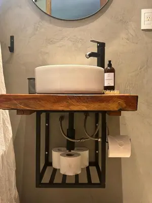 a bathroom counter with a sink and toilet paper at Anastasia Rústica y acogedora in Cordoba