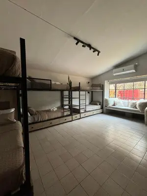 a room with bunk beds and a large window at Anastasia Rústica y acogedora in Cordoba