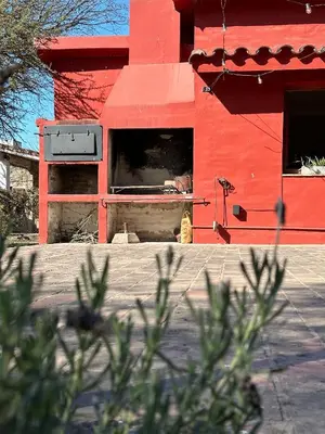 a person looking out of a window of a red building at Anastasia Rústica y acogedora in Cordoba