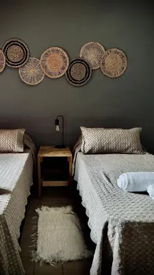 two beds in a room with plates on the wall at Anastasia Rústica y acogedora in Cordoba