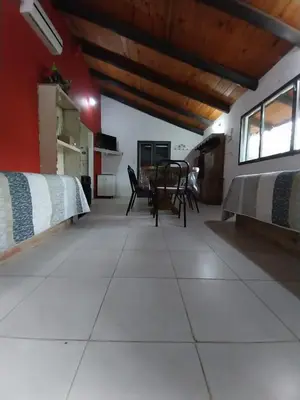 a room with a table and chairs on a tiled floor at Pintacho Cabañas, casa in Villa Anizacate
