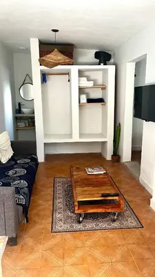 a living room with a coffee table and a couch at Casa Milos para dos personas frente al rio in Santa Rosa de Calamuchita