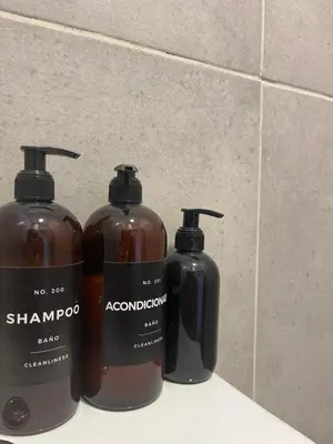 a group of three shampoo bottles sitting on a counter at Casa Milos para dos personas frente al rio in Santa Rosa de Calamuchita