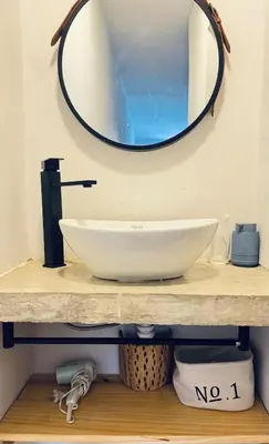 a bathroom counter with a sink and a mirror at Casa Milos para dos personas frente al rio in Santa Rosa de Calamuchita