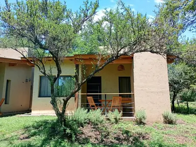 a house with a tree in front of it at Las Moras in Santa Rosa de Calamuchita
