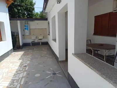 an empty hallway of a building with a table at Los Luises - Departamentos Céntricos in Mina Clavero