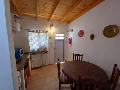a kitchen and dining room with a table and a counter at Los Luises - Departamentos Céntricos in Mina Clavero