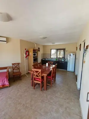 a kitchen and dining room with a table and chairs at Complejo Refugio Playa Perelli in Villa Carlos Paz